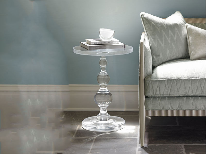 Transparent acrylic round table beside the sofa